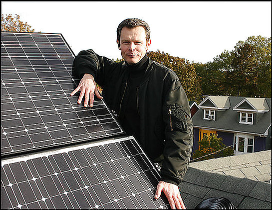 Ron McKay, on the roof of his home in east Toronto, has helped form a co-op in his neighborhood to buy solar panels at a bulk price.