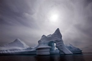 In this July 19, 2007 file photo, an iceberg melts off Ammassalik Island in Eastern Greenland. More than 2 trillion tons of land ice in Greenland, Antarctica and Alaska have melted since 2003, according to new NASA satellite data that show the latest signs of what scientists say is global warming.