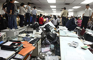 Factory workers smash an office during a protest at toy factory Kai Da in Dongguan, China, on Nov. 25