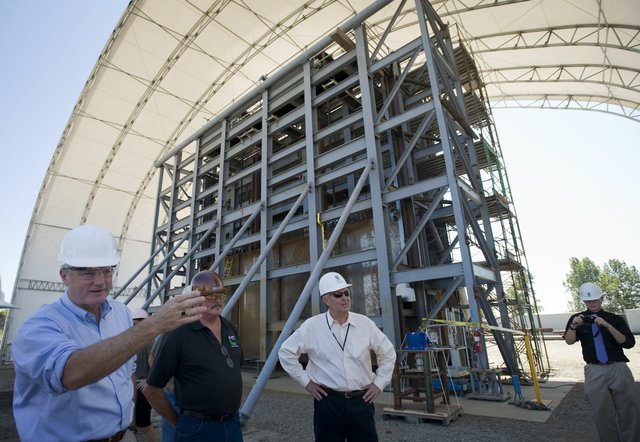 Congressman Brian Baird, left, stands before a nuclear shield door made at Oregon Iron Works in Vancouver. It will be used at the the Hanford power plant.