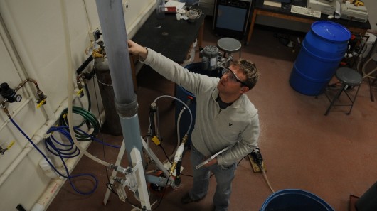The CO2 collecting smokestack with Michigan Tech chemical engineering PhD student Brett Sp...