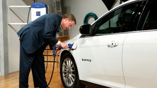 Ford Motor Company, Executive Chairman Bill Ford charges the Ford Focus Electric using the...
