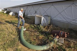  In this June, 28, 2012 photo, hog farmer Robert Young approaches the million gallon manure pit under the hog barn on his family farm in Buckhart, Ill. Young uses the manure to fertilize the fields of his own farm along with those he has contracted with in the area. Four years after the U.S. Government Accountability Office raised concerns and 40 years after the Clean Water Act gave the EPA the authority to protect the nation