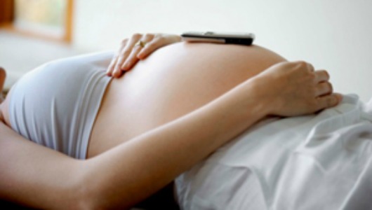 Pregnant woman with a cell phone