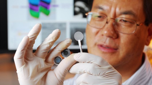 Georgia Tech researcher Zhong Lin Wang holds the components of a new self-charging power c...