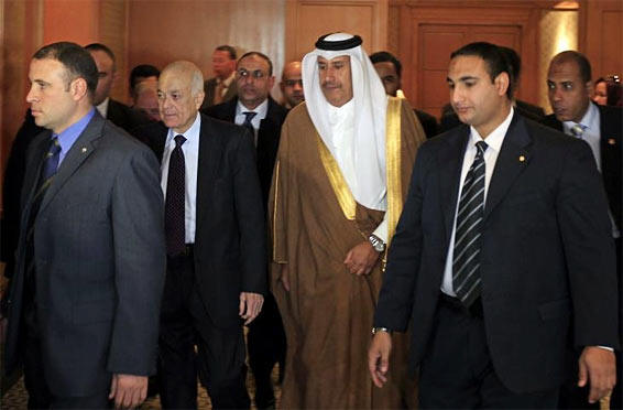 Arab League Secretary General Nabil al-Arabi (2nd L) and Qatari Prime Minister and Foreign Minister Sheikh Hamad bin Jassim Al-Thani (2nd R) arrive to chair the Arab League meeting in Cairo