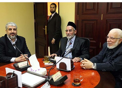 The leader of Hamas Khaled Meshaal, left, meets with Supreme Leader of the Muslim Brotherhood Mohamed Badie, centre, to congratulate him on their victory in the Egyptian Parliamentary elections on Saturday. 