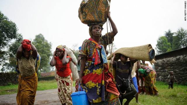 Congolese people flee a clash between M23 rebels and the Congolese army on the edge of the village of Rugarion on Thursday.
