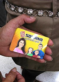 A woman shows her pre-paid gift card while waiting in line at a Soriana supermarket in Mexico City, Tuesday July 3, 2012. Many of the people at the supermarket say they went to redeem pre-paid gift cards they said were given them by the party that won Mexico's presidency and at least a few cardholders were angry, complaining they didn't get as much as promised, or that their cards weren't working. The incidents are inflaming accusations that the election was marred by massive vote-buying. (AP Photo/Marco Ugarte)