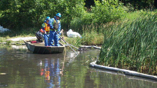 Workers help remove oil from the Kalamazoo River in 2011.