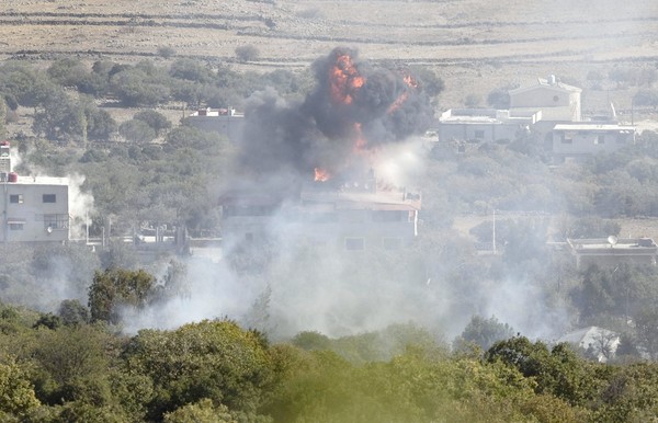 An explosion is seen in the Syrian village of Bariqa close to the ceasefire line between Israel and Syria on the Golan Heights