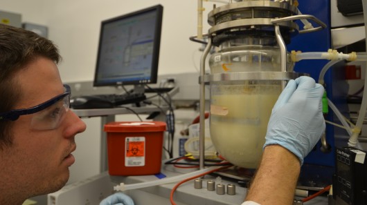 Graduate student Zachary Baer works with a fermentation chamber to separate acetone and bu...