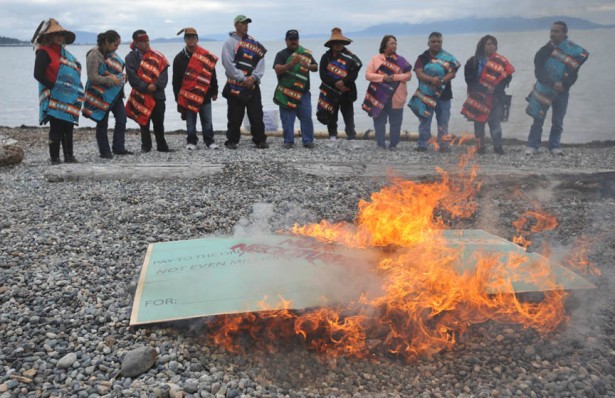 Coal Protest Members of the Lummi Nation protest the proposed coal export terminal at Cherry Point by burning a large check stamped "Non-Negotiable." The tribe says they want to protect the natural and cultural heritage of the site.