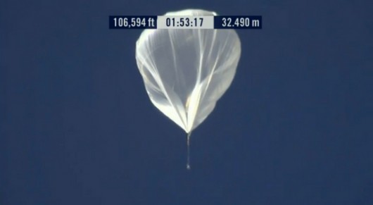 Telephoto image of the Red Bull Stratos balloon and capsule as it passes an altitude of 20...