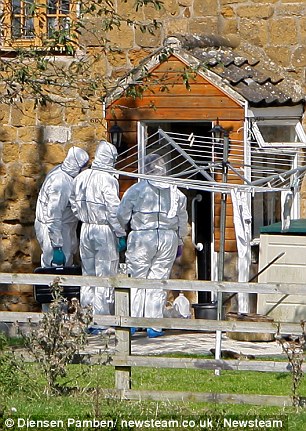 Police investigation: Forensic officers arrive at the house where Andy and Tracey Ferrie were arrested