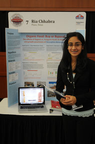 Ria Chhabra stands in front of her project.