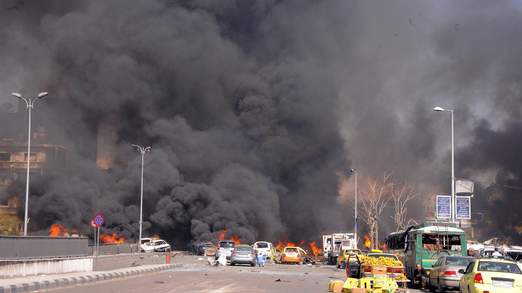 Cars burn after a boming in Damascus