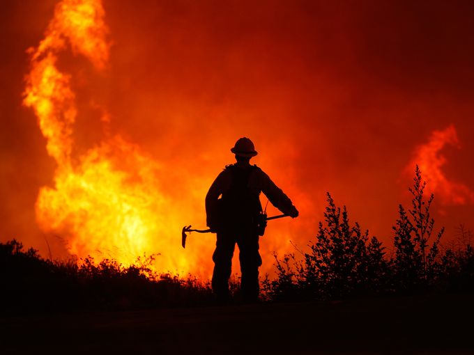 A firefighter watches as a wildire burns on June 3 in Lake Huges, Calif. The 19,500-acre wildfire destroyed numerous homes overnight.