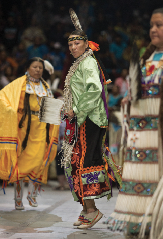 Traditional dancer Thelma Chickie Whitewater,  Ho-Chunk, dances on Saturday night. She recently moved to Nebraska after living in Albuquerque for many years. Im back home now, where the air is fresh and the land is green, Whitewater said.