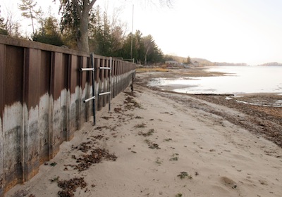 white streaks on a steel break wall show the normal water level on Portage Lake at Onekama, Mich., which is connected to Lake Michigan. (John Flesher/AP)