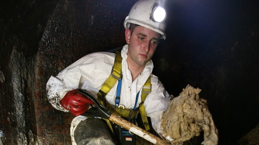 A Thames Water employee clearing fat from beneath London's Leicester Square