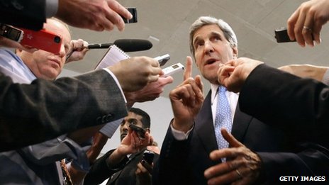 US Secretary of State John Kerry speaks with reporters at the U.S. Capitol before testifying to the Senate Banking and Urban Affairs Committee 13 November 2013