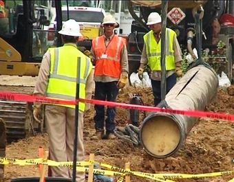 Officials assess the break in ExxonMobil's 838-mile Pegasus pipeline