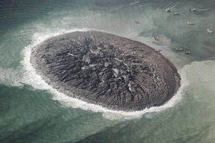 Pakistani residents gather to an island that appeared about 300 feet off the coastline of Gwadar after a 7.7 magnitude earthquake that killed hundreds on Tuesday, Sept. 24, 2013. 