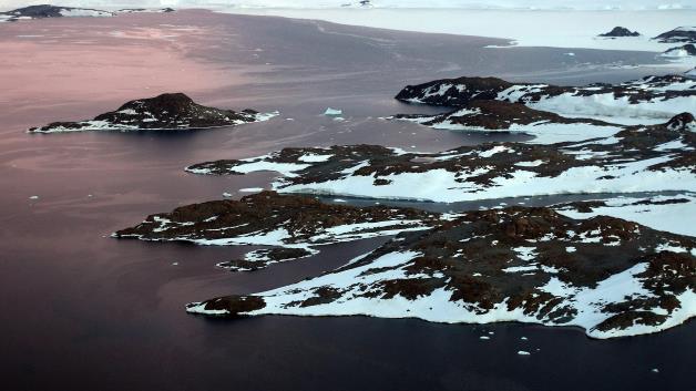 Global warming study: Barren rock near Cape Folger in the Australian Antarctic Territory: Barren rock is exposed near Cape Folger in the Australian Antarctic Territory. Experts are still unsure about the exact effects global warming will have in specific regions.