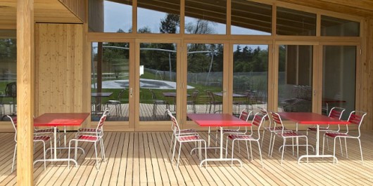 An on-site cafe offers refreshments and snacks, with wooden decking and grass providing a ...