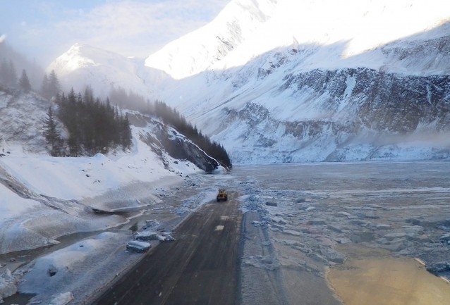 A photo released Wednesday Jan. 29, 2014, by the Alaska Department of Transportation & Public Facilities and made on Jan. 25, 2014, shows road crews beginning the job of clearing the closed Richardson Highway, near Valdez, Alaska.