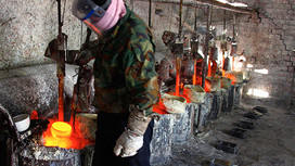 Ren Limin, a worker at the Jinyuan Company's smelting workshop, prepares to pour the rare earth metal Lanthanum into a mould