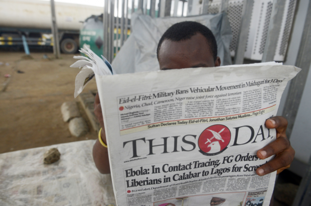A man reads a newspaper with a headline announcing government efforts to screen for Ebola at a newsstand in Lagos on July 27, 2014. Nigeria was on alert against the possible spread of Ebola on July 27, a day after the first confirmed death from the virus in Lagos, Africa's biggest city and the country's financial capital. The health ministry said on July 25 that a 40-year-old Liberian man died at a private hospital in Lagos from the disease, which has now killed more than 650 people in four west African countries since January. ( Title NIGERIA-HEALTH-DISEASE-EPIDEMIC-EBOLA-LIBERIA Caption A man reads a newspaper with a headline announcing government efforts to screen for Ebola at a newsstand in Lagos on July 27, 2014. Nigeria was on alert against the possible spread of Ebola on July 27, a day after the first confirmed death from the virus in Lagos, Africa's biggest city and the country's financial capital. The health ministry said on July 25 that a 40-year-old Liberian man died at a private hospital in Lagos from the disease, which has now killed more than 650 people in four west African countries since January. (PIUS UTOMI EKPEI/AFP/Getty Images)