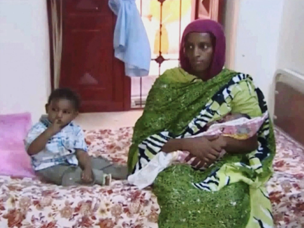 Meriam Ibrahim, sitting next to Martin, her 18-month-old son, holds her newborn baby girl that she gave birth to in jail. Sudan's official news agency, SUNA, said  a court cancelled the death sentence against the 27-year-old  on Monday.  