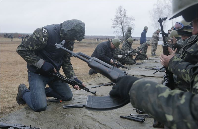 Self-Defense activists perform military exercises at a military training ground outside Kiev, Ukraine, Monday. Ukraine's parliament on Monday voted partial mobilization in response to Russia's invasion onto the Ukrainian territory.
