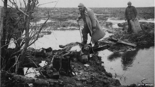 Two men searching for war material and other valuables after a battle near Ypres on 19 April 1918