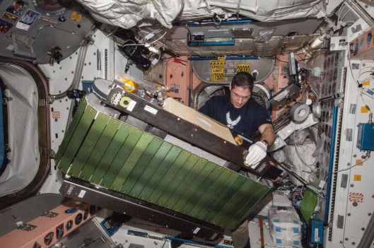 Astronaut Mike Hopkins setting up the COLBERT treadmill (Photo: NASA)