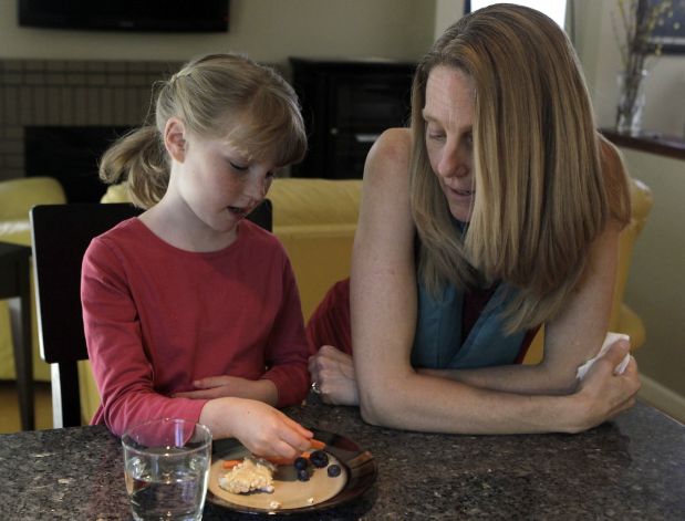 Brooke Reid, 7, enjoys an afternoon snack with her mother, Katherine, at their home in Fremont. Katherine Reid says all signs of Brooke's autism vanished when the compound monosodium glutamate was eliminated from her diet. Photo: Paul Chinn, The Chronicle