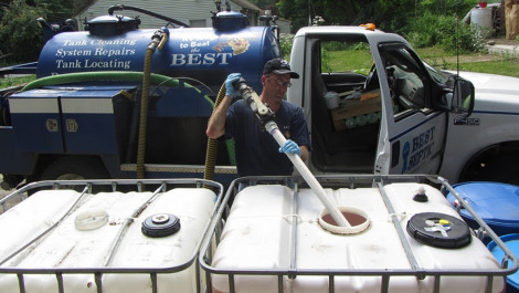 Seth True of Best Septic Service, LLC, pumps urine from a 275-gallon tank for transfer to the farm. A family of three can produce this much urine in eight months.