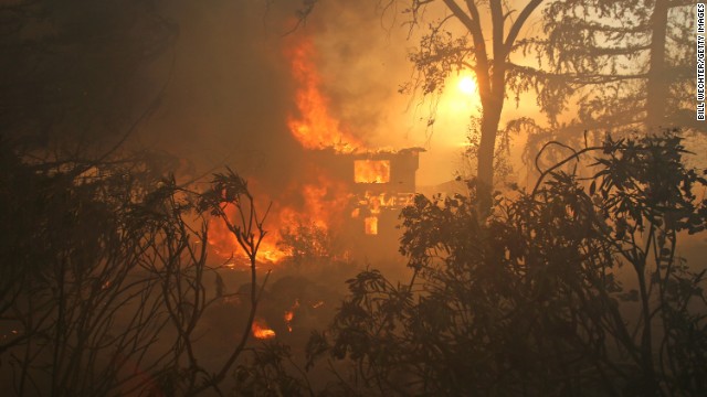 A house is consumed by a wildfire in San Marcos, California, on Wednesday, May 14. A couple of wildfires have forced evacuations in San Diego County after a high-pressure system brought unseasonable heat and gusty winds to the parched state.