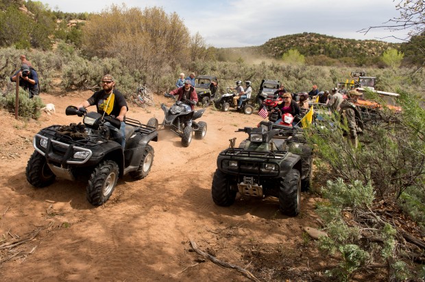ATV riders cross into a restricted area of Recapture Canyon, north of Blanding, Utah, on Saturday, May 10, 2014, in a protest against what demonstrators call the federal government's overreaching control of public lands. The area has been closed to motorized use since 2007 when an illegal trail was found that cuts through Ancestral Puebloan ruins. The canyon is open to hikers and horseback riders. (AP Photo/The Salt Lake Tribune, Trent Nelson)