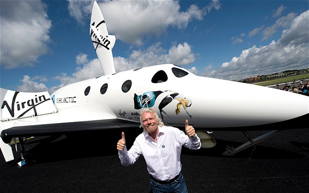 British billionaire Richard Branson with a model of the Virgin Galactic at the 2012 Farnborough Airshow