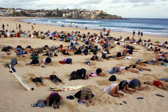 Australians bury heads in sand to mock government climate stance Photo: David Gray