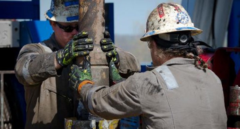 US workers change pipes at Consol Energy horizontal gas drilling rig fracking (AFP)