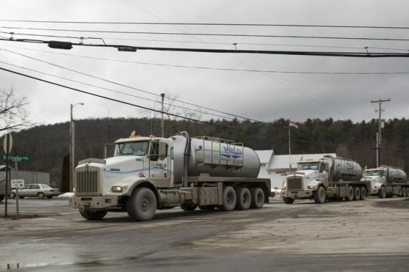 A line of trucks carrying water to Natural gas rigs make their way across the sprawling network of two lane roads between small towns to make almost constant deliveries to continue the hydraulic fracturing process used to gather natural gas in Monroeton, Pennsylvania, January 13, 2013. REUTERS/Brett Carlsen