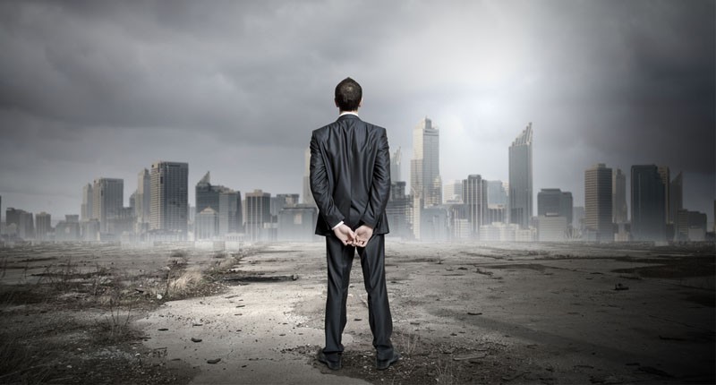 Businessman looking at scene of polluted city (Shutterstock)