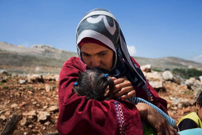 Lina, a Syrian refugee, comforts one of her children in Lebanon. Photo courtesy UNCHR.org.