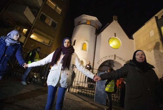 More than 1,000 people formed a "ring of peace" around the Norwegian capital's synagogue, an initiative taken by young Muslims in Norway after a series of attacks against Jews in Europe, in Oslo, Saturday, Feb. 21 2015. Norways Chief Rabbi Michael Melchior sang the traditional Jewish end of Shabaat song outside the Oslo synagogue before a large crowd holding hands. (AP Photo/Hakon Mosvold Larsen / NTB Scanpix)