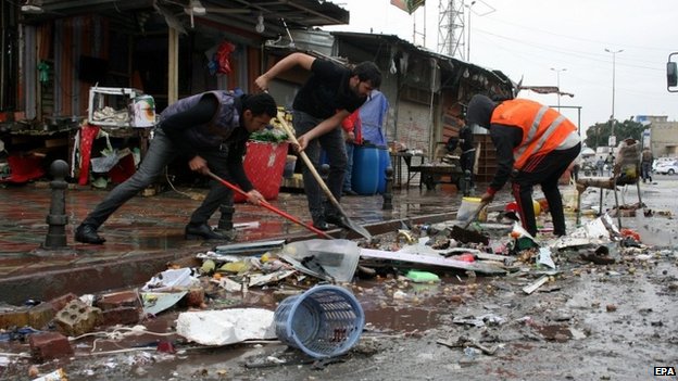 Iraqis remove debris after a bomb attack at new Baghdad district in eastern Baghdad, Iraq, 07 February 2015