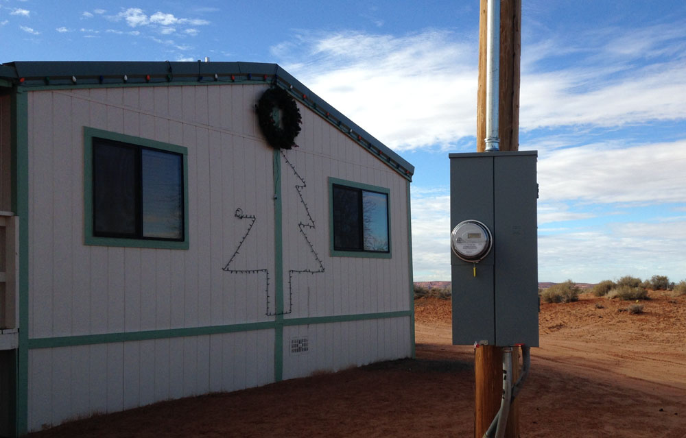 Carol Bigthumb waited her whole life for electricity at her home in Lechee, Arizona. She put Christmas lights up for the first time in 2014. (Courtesy Navajo Tribal Utility Authority)